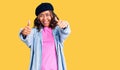 Young beautiful mixed race woman wearing french look with beret approving doing positive gesture with hand, thumbs up smiling and Royalty Free Stock Photo