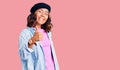 Young beautiful mixed race woman wearing french look with beret doing happy thumbs up gesture with hand Royalty Free Stock Photo