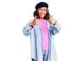 Young beautiful mixed race woman wearing french look with beret success sign doing positive gesture with hand, thumbs up smiling Royalty Free Stock Photo