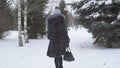 Young beautiful model posing over winter forest. Stylish fashion portrait. Outdoor winter portrait of young brunette