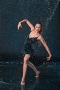 The young beautiful modern dancer dancing under water drops Royalty Free Stock Photo