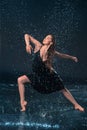 The young beautiful modern dancer dancing under water drops Royalty Free Stock Photo