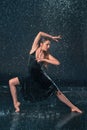 The young beautiful modern dancer dancing under water drops Royalty Free Stock Photo