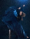 The young beautiful modern dancer dancing under water drops