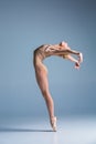 Young beautiful modern style dancer posing on a studio background