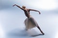 Young beautiful modern style dancer posing on a studio background Royalty Free Stock Photo