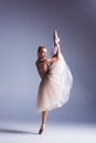 Young beautiful modern style dancer posing on a studio background Royalty Free Stock Photo