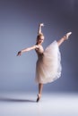 Young beautiful modern style dancer posing on a studio background Royalty Free Stock Photo