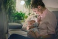 Young beautiful mother, breastfeeding her newborn baby boy Royalty Free Stock Photo