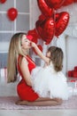 Happy mother and daughter parses gifts on Valentine`s Day Royalty Free Stock Photo