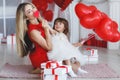 Happy mother and daughter parses gifts on Valentine`s Day Royalty Free Stock Photo