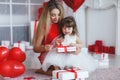 Happy mother and daughter parses gifts on Valentine`s Day Royalty Free Stock Photo