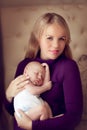 Young beautiful mother holding sleeping newborn baby on hands in Royalty Free Stock Photo