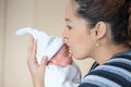 Young beautiful mother at the hospital kissing her newborn girl on the day of her birth. Motherhood concept Royalty Free Stock Photo