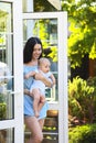 Young beautiful mother hugging her little baby son outdoors. Mom and baby boy having fun together in green garden Royalty Free Stock Photo