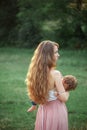 Young beautiful mother hugging her little toddler son against green grass. Happy woman with her baby boy on a summer Royalty Free Stock Photo