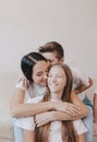 Young beautiful mother hugs her daughter all together smiling happily. the concept of the joy of family happiness Royalty Free Stock Photo