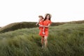 Young beautiful mother and little daughter walking on nature on summer day vacation. Mom and girl playing in the field at the Royalty Free Stock Photo