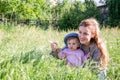 Young beautiful mother playing in the grass with her little baby daughter in panama Royalty Free Stock Photo