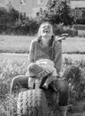 Young beautiful mother playing with her daughter on the playground in the grass sitting on wheels black and white photo Royalty Free Stock Photo