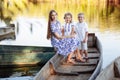 young beautiful mother spending time together with children in boat on lake at park. mothers day. womens day. Royalty Free Stock Photo