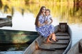 young beautiful mother spending time together with children in boat on lake at park. mothers day. womens day. Royalty Free Stock Photo