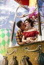 Young beautiful multiethnic couple kissing in the hot air balloon. Royalty Free Stock Photo