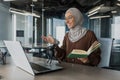 Young beautiful muslim woman in hijab working in modern office using professional microphone Royalty Free Stock Photo