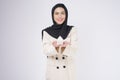 Young beautiful muslim woman in suit holding small model house over white background studio Royalty Free Stock Photo