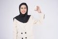 Young beautiful muslim woman in suit holding small model house over white background studio Royalty Free Stock Photo