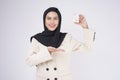 Young beautiful muslim woman in suit holding small model house over white background studio Royalty Free Stock Photo