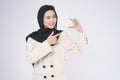 Young beautiful muslim woman in suit holding small model house over white background studio Royalty Free Stock Photo