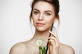 Young beautiful naked girl with perfect clean skin smiling looking at camera holding glass of water with cucumber slices Royalty Free Stock Photo