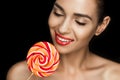 Young beautiful naked woman with red lips holding lollipop Royalty Free Stock Photo