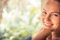 Young beautiful happy smiling tanned woman looking at camera portrait sunny day with copy space during tropical summer holidays Royalty Free Stock Photo