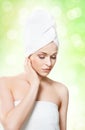 Young, beautiful and natural woman wrapped in towel isolated on Royalty Free Stock Photo