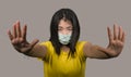 Young beautiful pacifist Asian woman in face mask angry and outraged protesting showing clean hands as symbol of peace standing