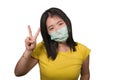 Young beautiful pacifist Asian woman in face mask angry and outraged protesting showing clean hands as symbol of peace standing