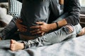 Young beautiful pair of lovers hug and kiss. Cropped image. Legs in grey ragged jeans Royalty Free Stock Photo