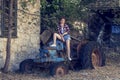 Young, beautiful pin up girl sitting on a retro tractor close-up Royalty Free Stock Photo