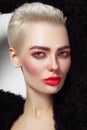 Young beautiful platinum blond glamorous woman with red mascara