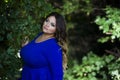 Young beautiful plus size model in blue dress outdoors, xxl woman on nature Royalty Free Stock Photo