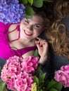 Young beautiful plus size model lying in flowers, xxl woman