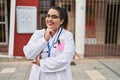 Young beautiful plus size woman doctor smiling confident standing with arms crossed gesture at hospital Royalty Free Stock Photo