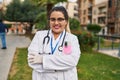 Young beautiful plus size woman doctor smiling confident standing with arms crossed gesture at park Royalty Free Stock Photo