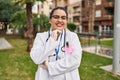 Young beautiful plus size woman doctor smiling confident standing with arms crossed gesture at park Royalty Free Stock Photo