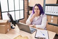 Young beautiful plus size woman ecommerce business worker tired yawning at office Royalty Free Stock Photo