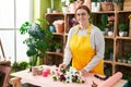 Young beautiful plus size woman florist make bouquet of flowers at flower shop Royalty Free Stock Photo