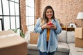 Young beautiful plus size woman smiling confident drinking coffee at new home Royalty Free Stock Photo