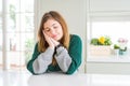 Young beautiful plus size woman wearing casual striped sweater sleeping tired dreaming and posing with hands together while Royalty Free Stock Photo